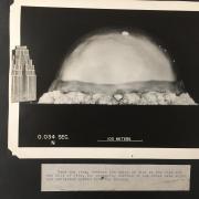 Image of the Trinity Test blast from July 16, 1945 with a building for scale 