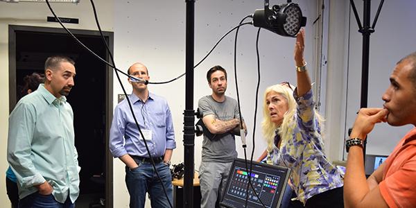 A faculty member demonstrating lighting equipment during RMLA