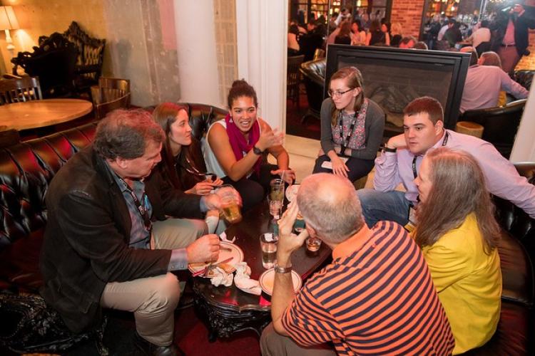 A group of students and professionals gather.