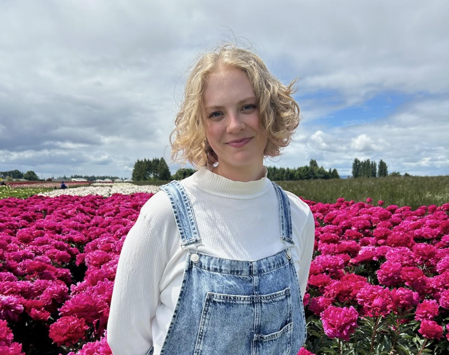 Izzy in a field of pink flowers