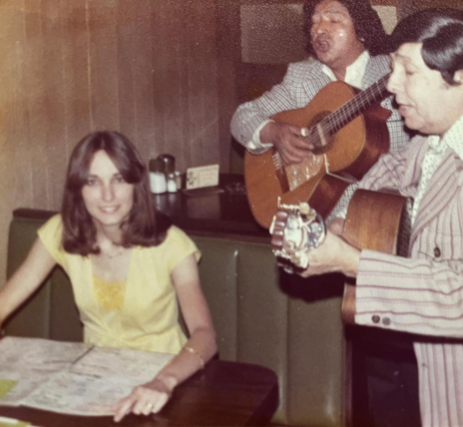 Dr. Palmer being serenaded by 2 guitar players