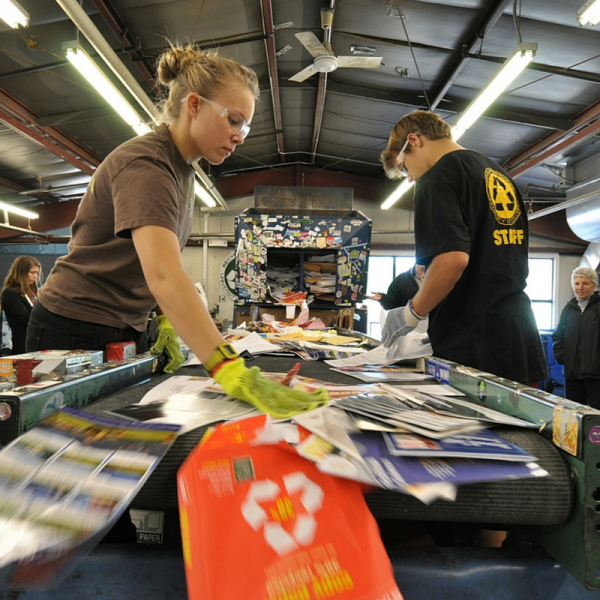 Two student staff members sorting recycled materials