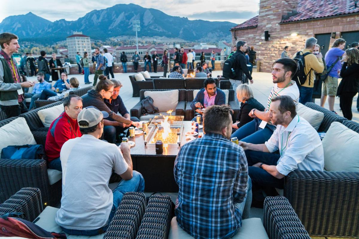 Attendees sitting around a fire pit, talking