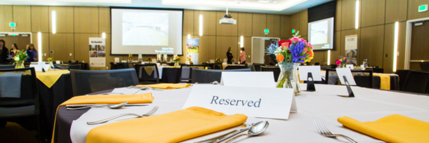 Village Center conference room set up for a dinner with linen and flatwear