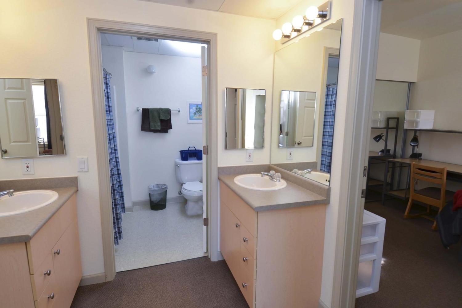 Bathroom area with two vanities and one shower area
