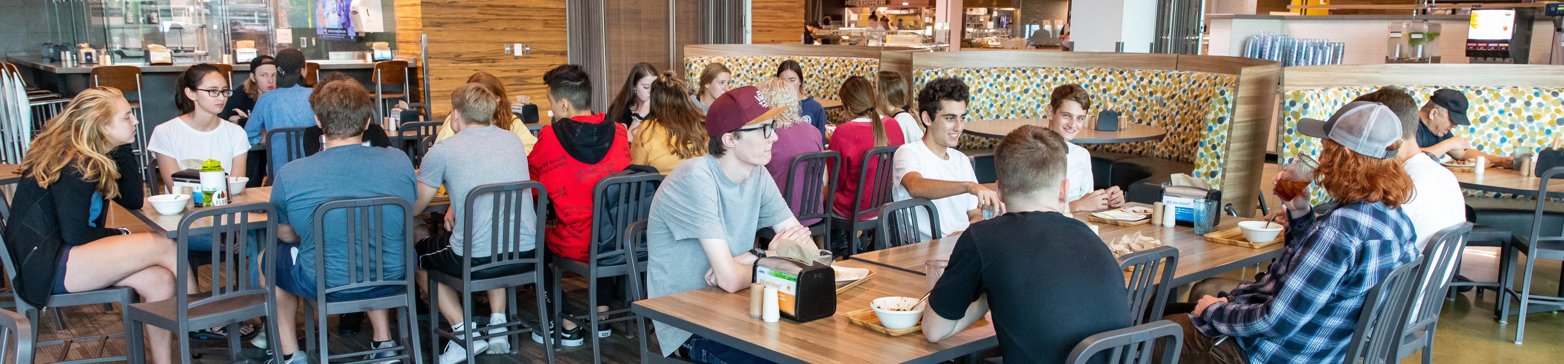 Students eating in the village center