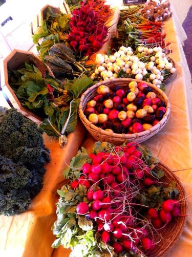 A variety of vegetables in baskets.