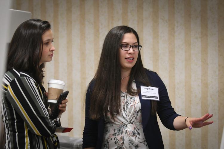 Angelique Sayler presents a research poster