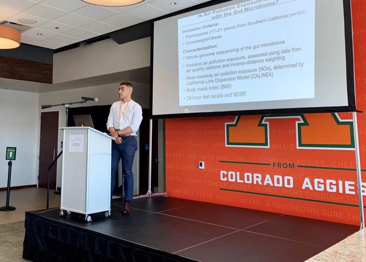 Max Bailey presents research at a podium