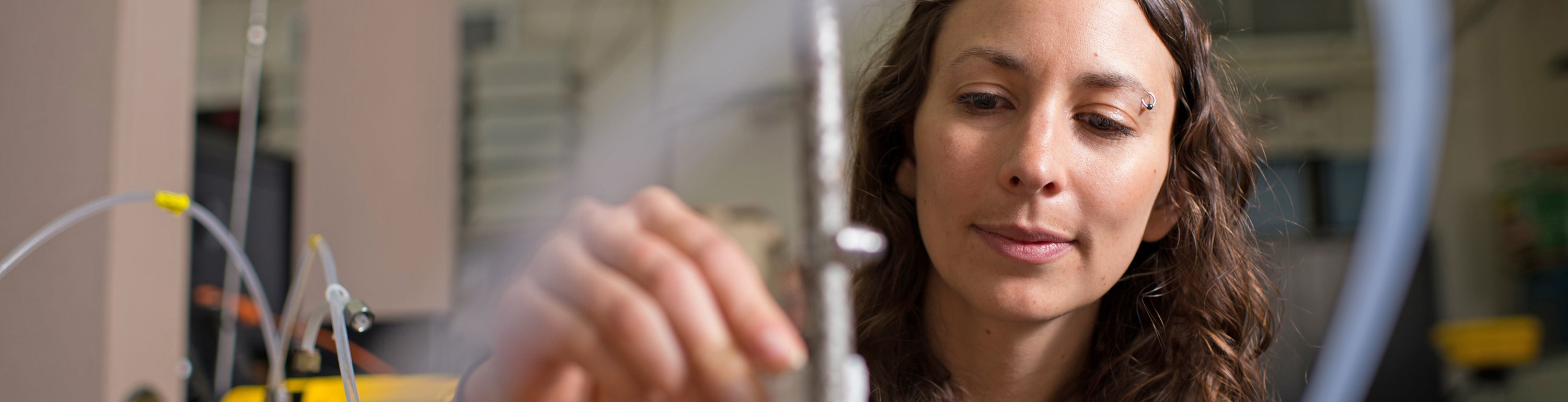 graduate student adjusting air quality tubes