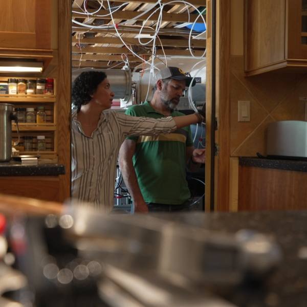 Two people speaking to each other in a kitchen