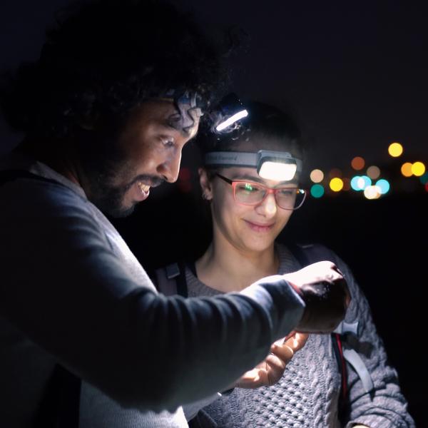 Kaushik and student in a field at night