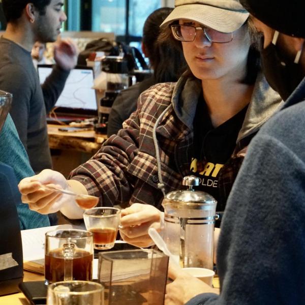 Students prepare to taste their coffee