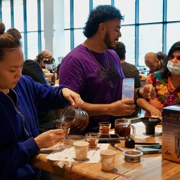 Cordelia Kim pours coffee to taste it
