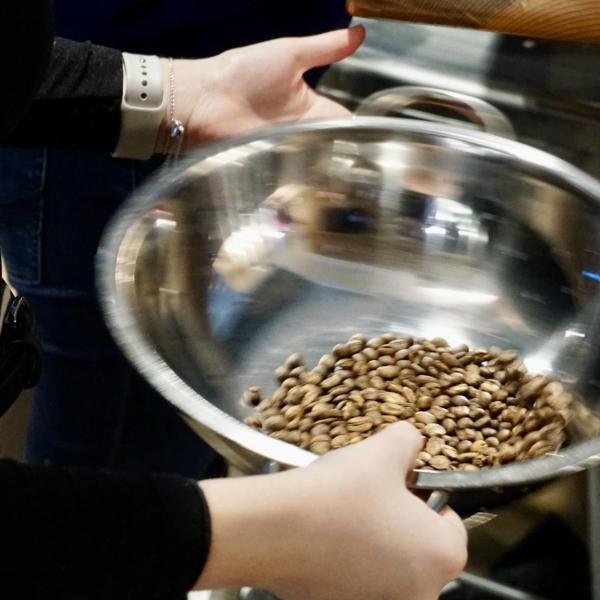 Students cool the roasted beans before brewing