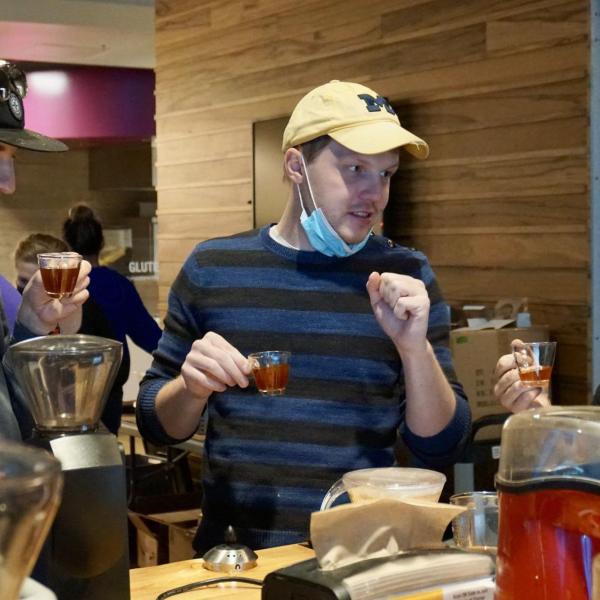 Students taste their coffee after roasting