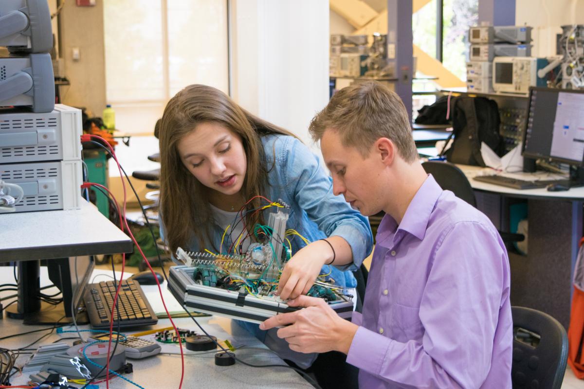 Two students working on a mechatronics robot.
