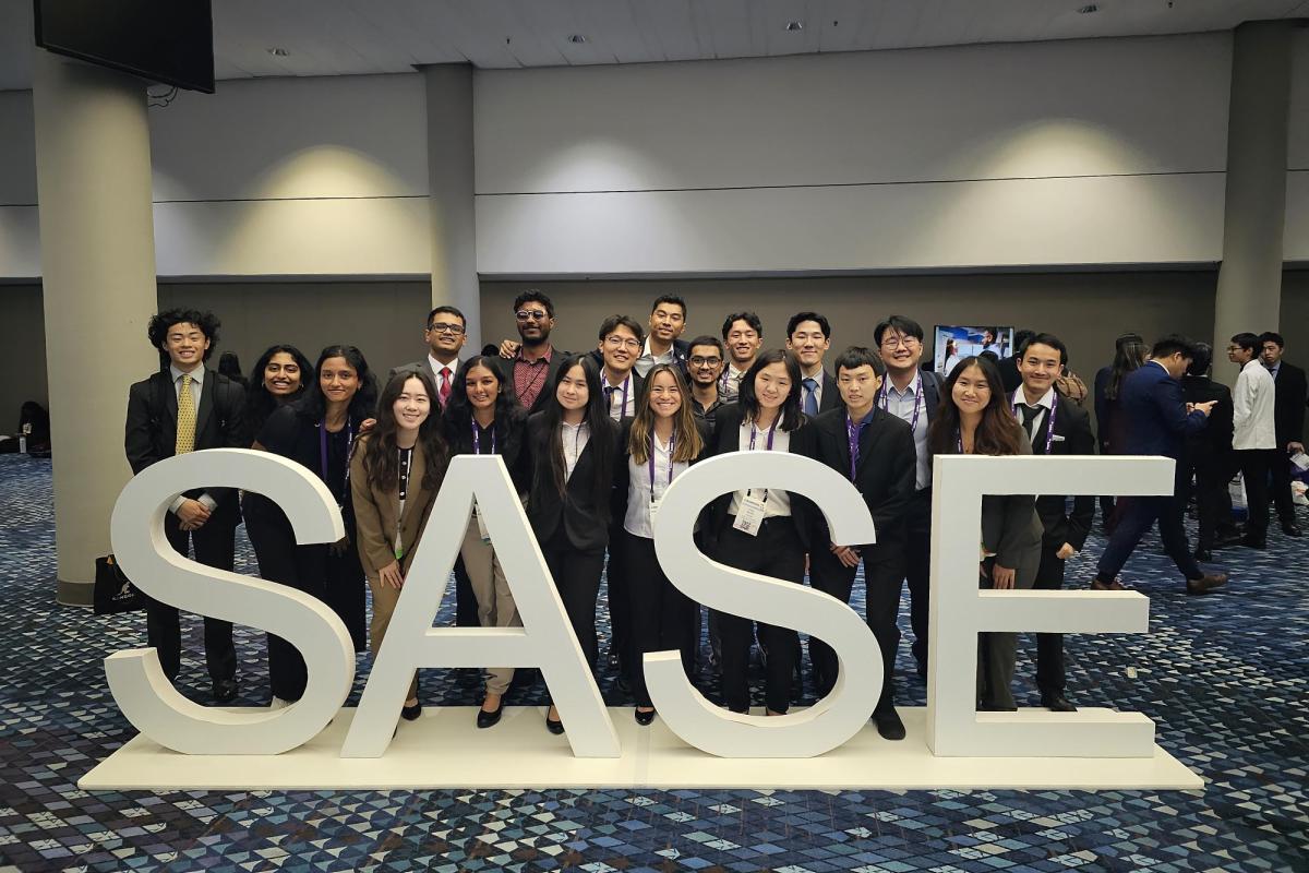 Group of students behind SASE sign