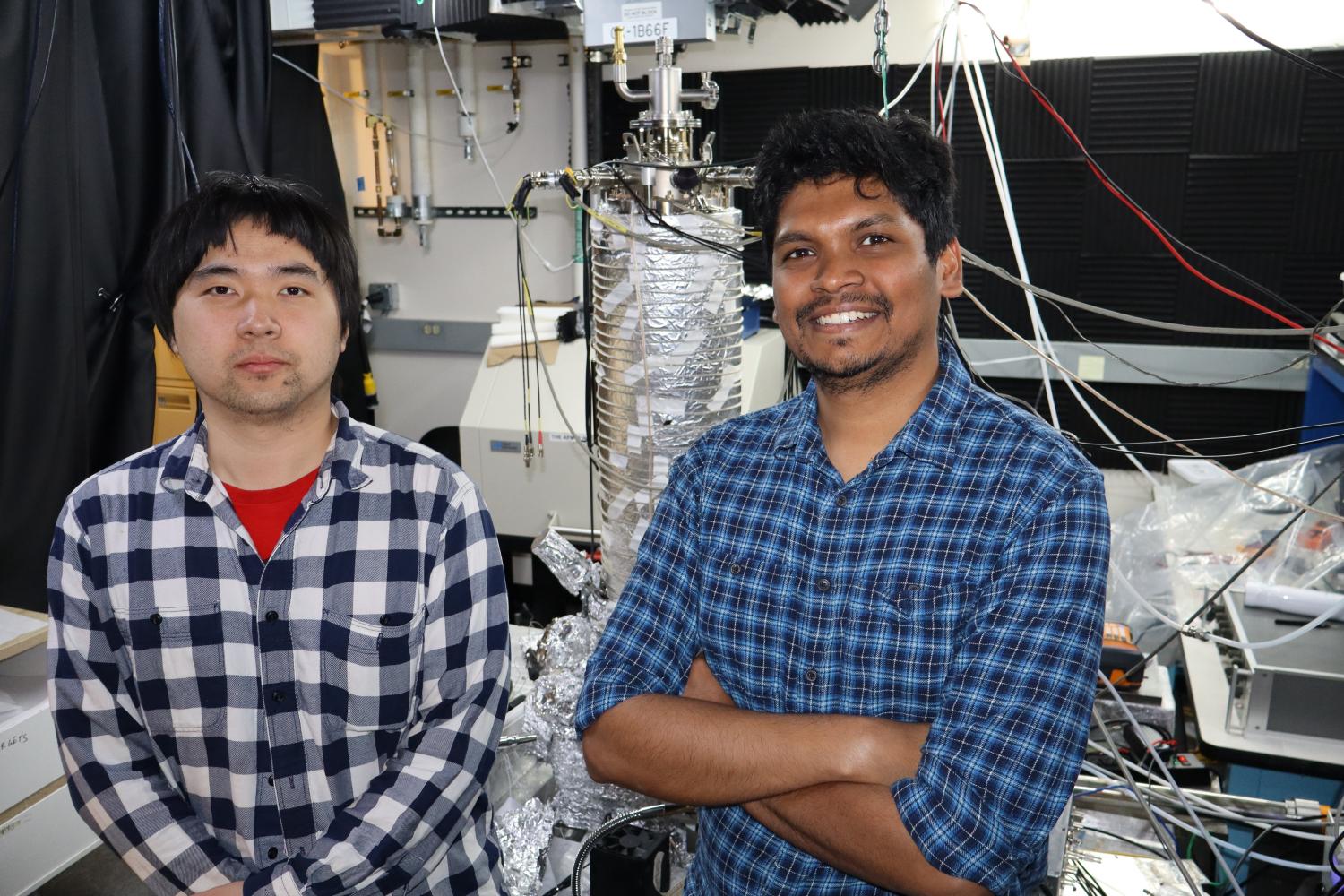 Two students posing for picture in their lab space