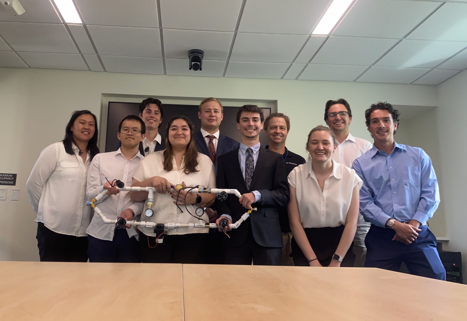 hydropower team students posing for group photo with testing apparatus