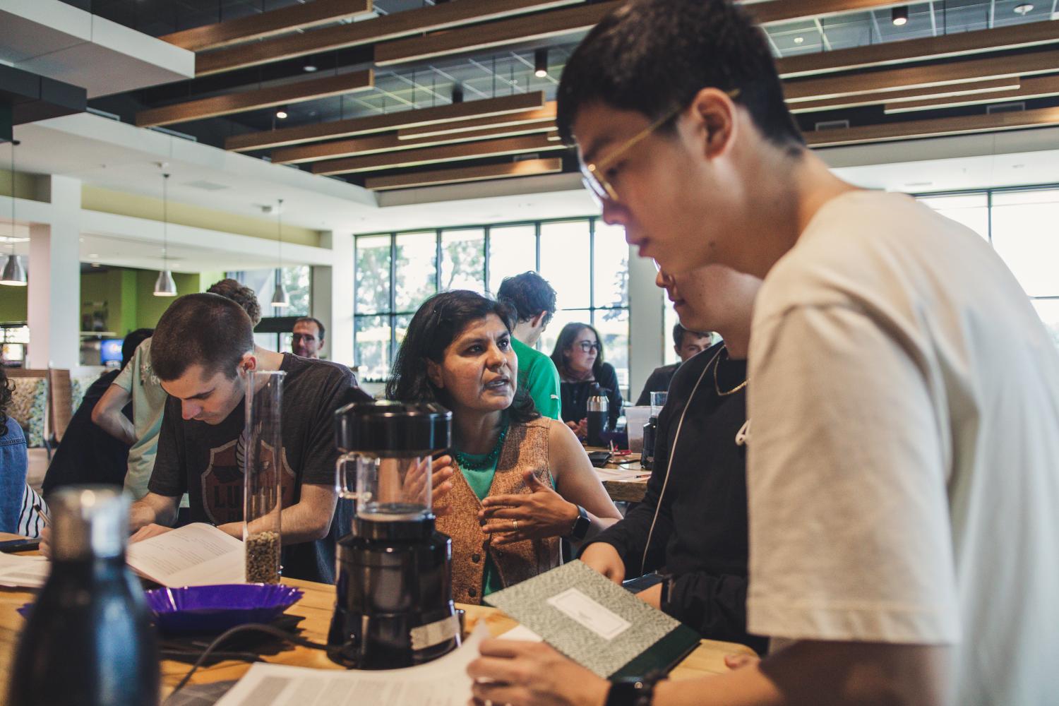 Carmen Pacheco talking and working with students in Design of Coffee course