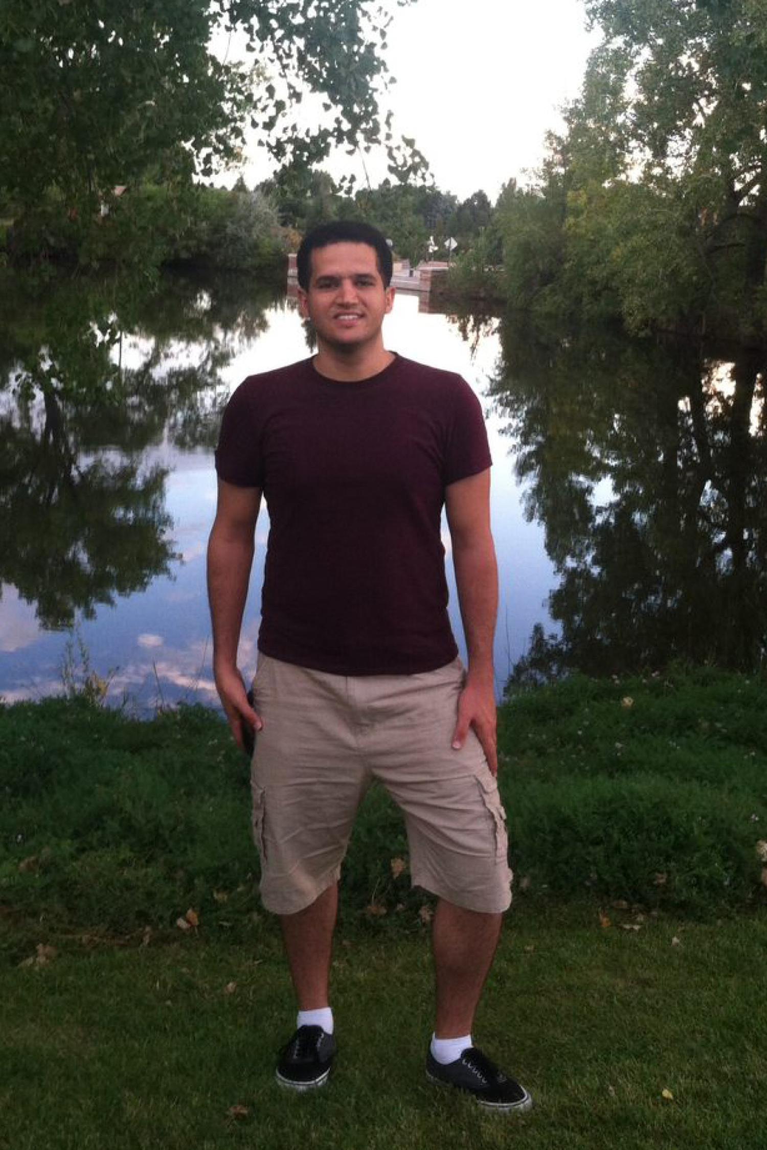 Masoud Aghajani standing by a lake.