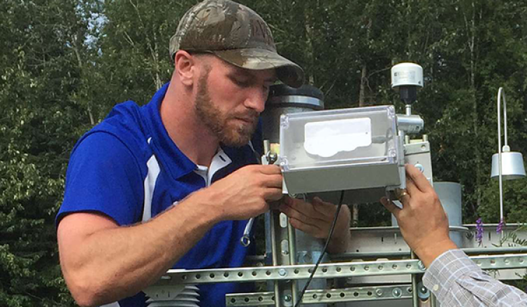 Isaac Koch works on a piece of equipment.