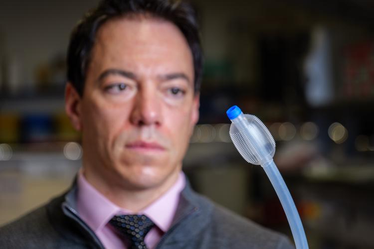 Mark Rentschler holding an Aspero Medical medical device