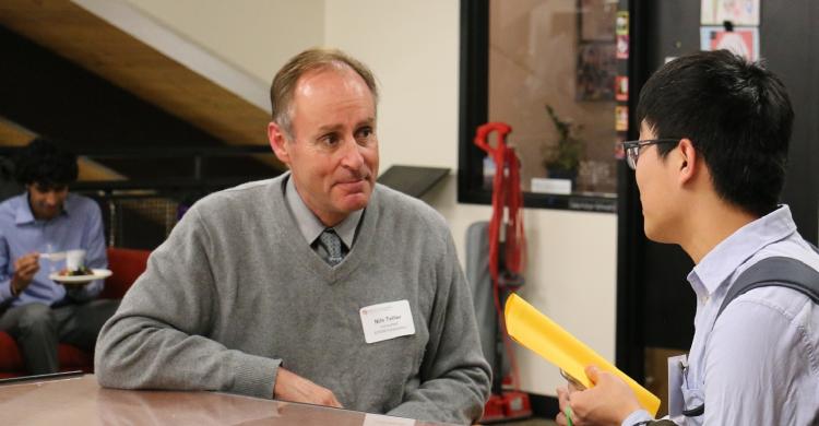 Alumnus Nils Tellier with a student.