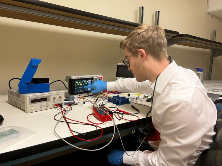 Palmer Dick-Montez at an electronics workstation.