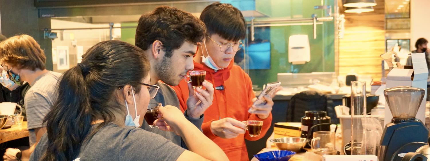 Students tasting their coffee.