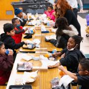 Young students eating lunch in the cafeteria 