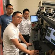 Ronggui Yang in a lab with two students.