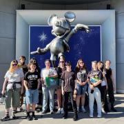 The oSTEM students in front of a Mickey Mouse statue at Disneyland