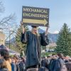 Woman holding a sign that says "mechanical engineering"