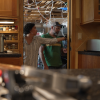 Two people speaking to each other in a kitchen