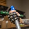 woman holding a broom with prosthetic fingers