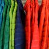 a photo showing multiple different colors of jackets hung up next to each other
