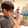Jaejune Lee plays with a prototype of the Rain Game. (Credit: Jade Cody/Boulder Valley School District)