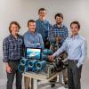 The senior design team with the test rig.