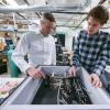 Greg Rieker (left) and a student discuss a project in their lab
