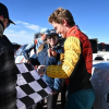 Nichols signs an autograph at the top of Pikes Peak after completing the race