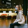 girl in airport wearing mask