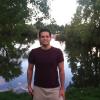 Masoud Aghajani standing by a lake.