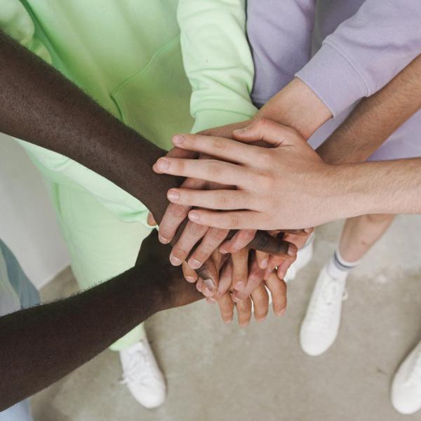 Photo of hands on top of each other.