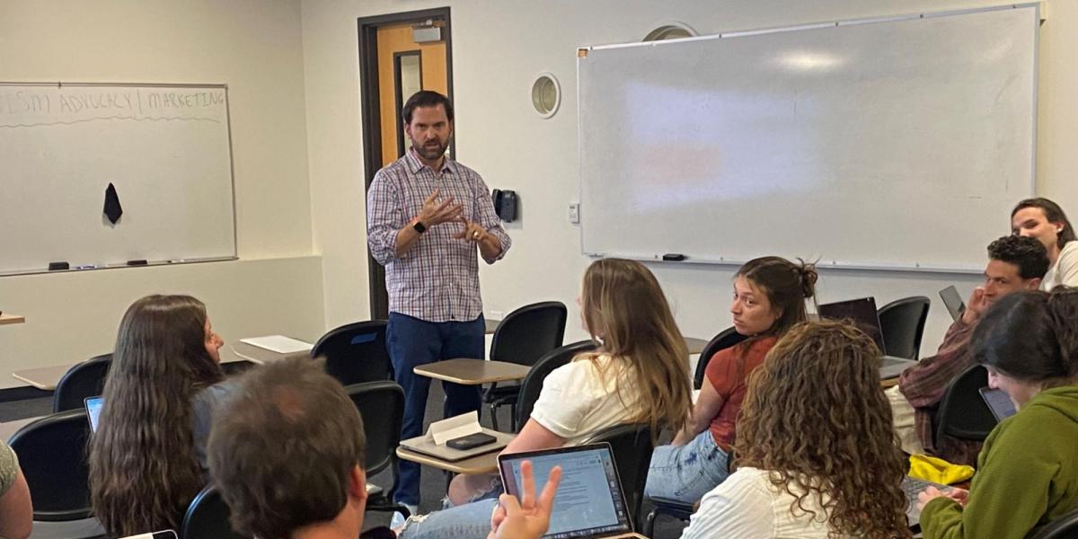 Luis Benitez teaching a group of students.
