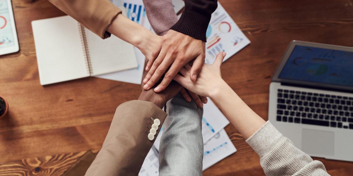 Hands together in the center of the photo.
