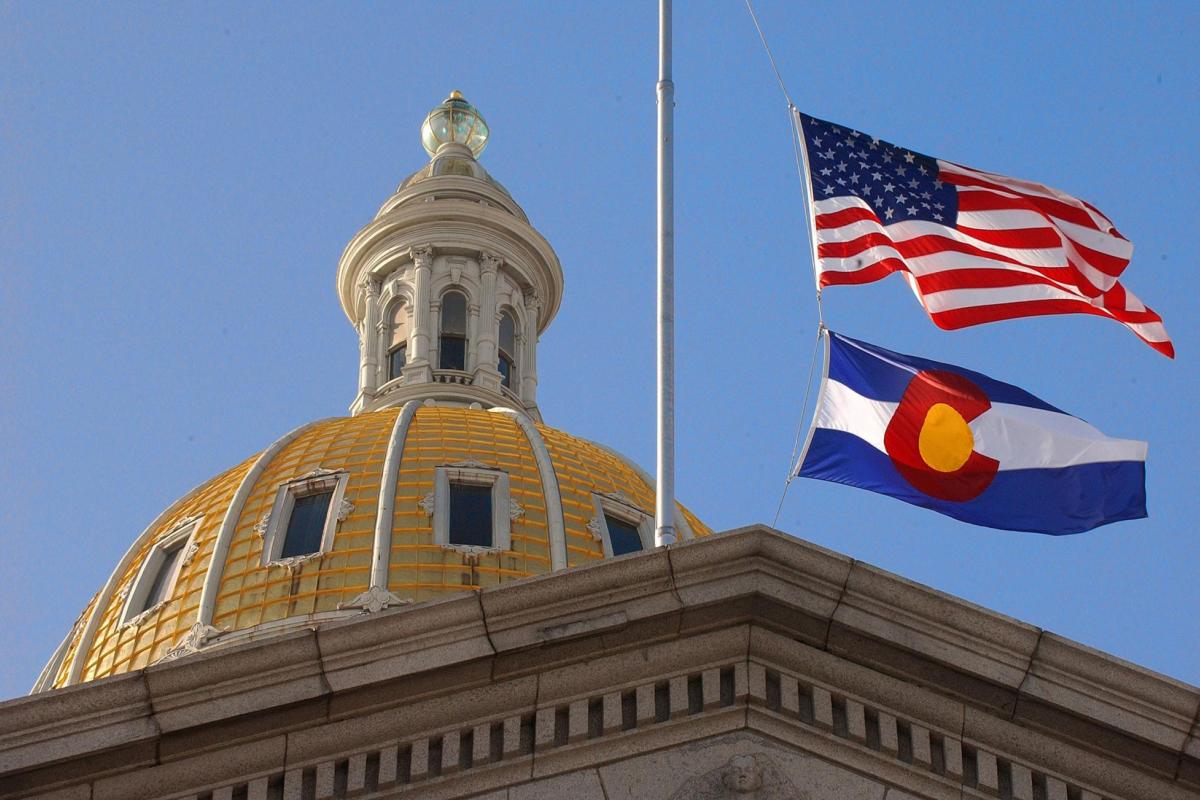 Colorado State Capitol with CO and US flags.