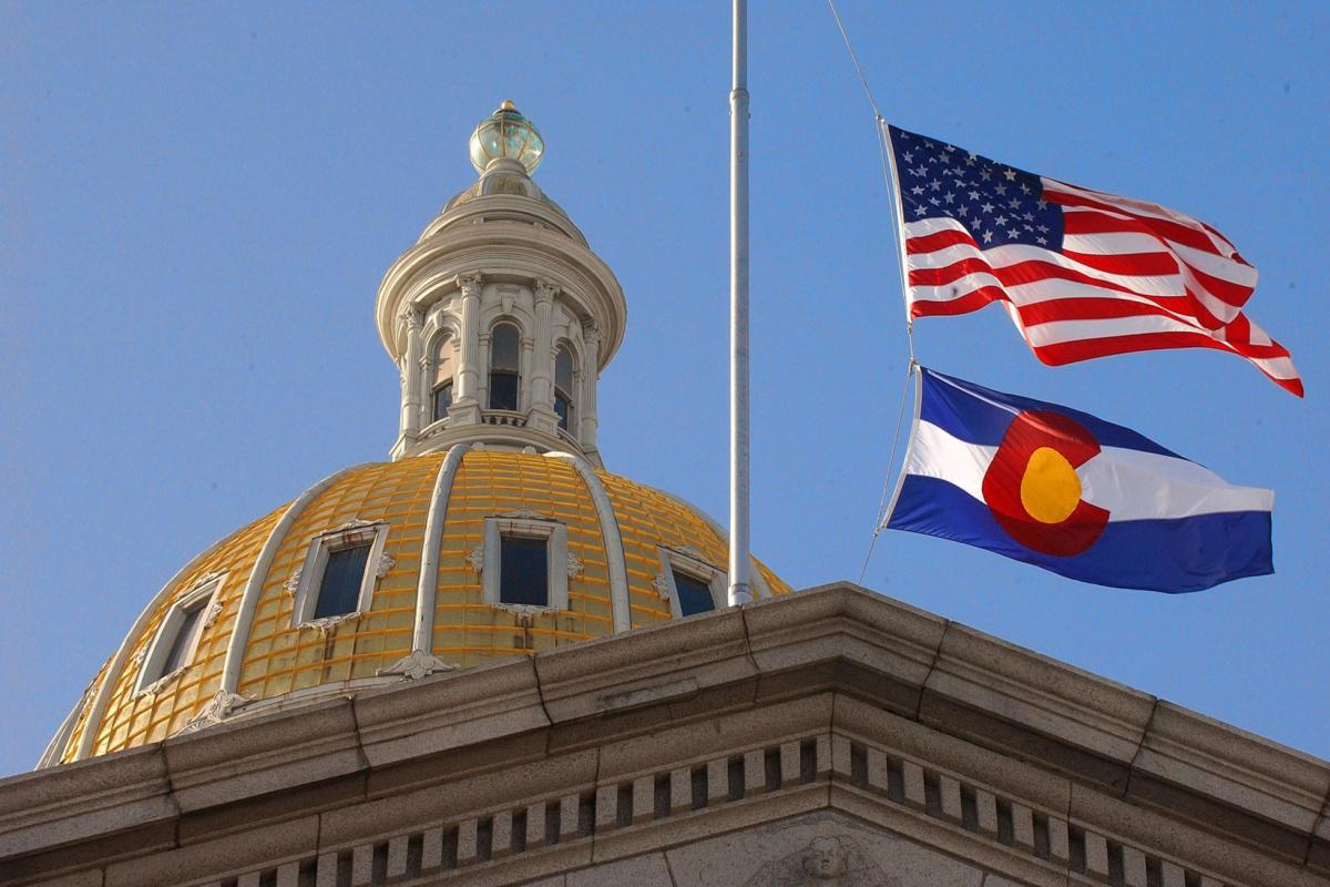 Colorado State Capitol with CO and US flags.