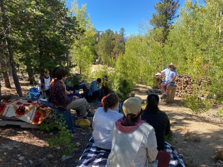Gregor teaching a group of students in the woods.